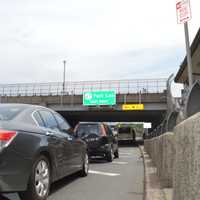 <p>Vehicles wait to pick up commuters to take them across the bridge.</p>