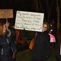 <p>Demonstrators hold sign at a Chappaqua interfaith vigil meant to protest President Donald Trump's ban on admission of refugees.</p>