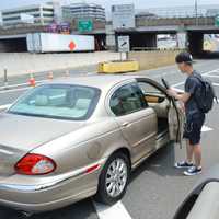 <p>A commuter gets into a car.</p>