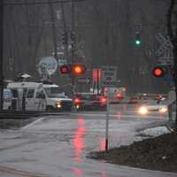 <p>Broadcast journalists were present Wednesday afternoon at the Commerce Street crossing in Valhalla on the one-year anniversary of the deadly collision. A news truck is pictured in the distance.</p>