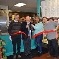 <p>Fairfield First Selectman Michael Tetreau, second from left, and owner Alicia Connelly, second from right, cut the ribbon on her business, D. Lish &amp; Co. in Fairfield.</p>