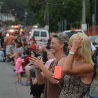 <p>An onlooker applauds at the Mahopac Volunteer Fire Department&#x27;s dress parade.</p>