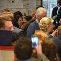 <p>Hillary and Bill Clinton are surrounded by spectators as they walk through the auditorium of Douglas G. Grafflin Elementary School in Chappaqua. The Clintons arrived to cast their presidential votes.</p>