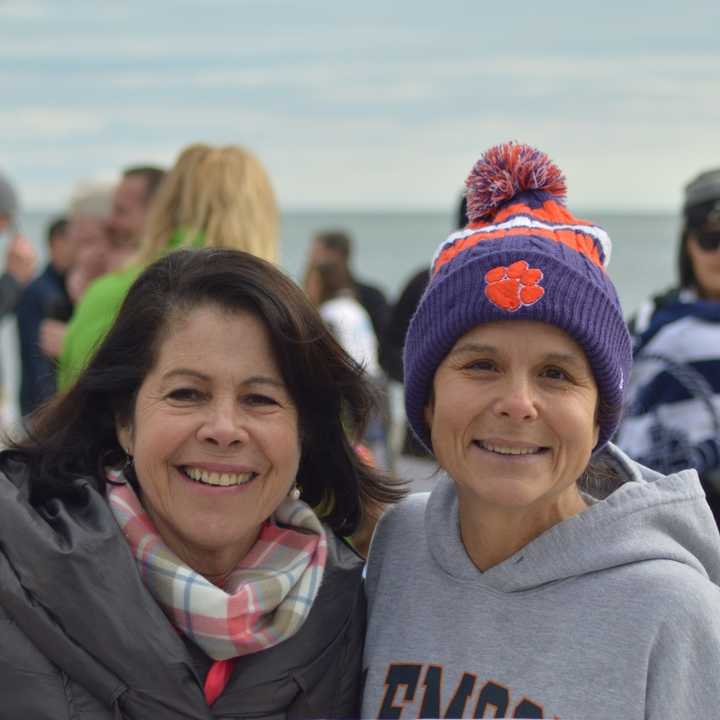 Angela Swift (right) has been a regular participant in the Old Greenwich on New Year&#x27;s Day Dip at Tod&#x27;s Point for many years. She also came up with the idea of selling T-shirts to benefit Kids in Crisis.