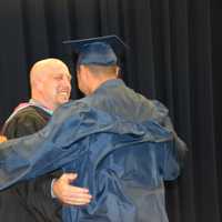 <p>A newly minted Carmel High School graduate receives his diploma at the 2016 commencement.</p>