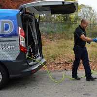 <p>Walking between vehicles, with a top-down oil extractor closest to the customer's car.</p>
