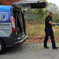 <p>Walking between vehicles, with a top-down oil extractor closest to the customer&#x27;s car.</p>