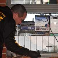 <p>Bergen County Sheriff&#x27;s Bureau of Criminal Identification forensics investigator gathers evidence following what local police said was an aborted burglary at Hudson Drug on Union Avenue in Cresskill.</p>