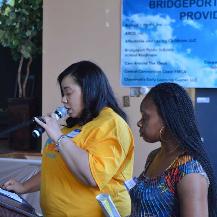 Chantel, a single mother of three, tells her story at a Bridgeport legislative forum, while Kenya Moales-Bird, director of Kingdom&#x27;s Little Ones, looks on.