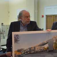 <p>Architect Ira Grandberg (left) and attorney Charles Martabano (right) present a proposal for a new building for downtown Mount Kisco at a Planning Board meeting.</p>