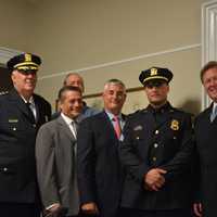 <p>Newly minted Police Chief Charles Beckett (left) and Police Sergeant David Alfano (center) pose for photos with members of the Lewisboro Town Board.</p>