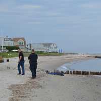 <p>Fairfield police wait with the body of a man who washed up on shore Thursday afternoon.</p>