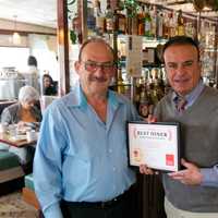 <p>Daily Voice Director of Media Initiatives/Managing Editor Joe Lombardi, right, presents first-place plaque to Coach Diner owner Nick Karkambasis.</p>