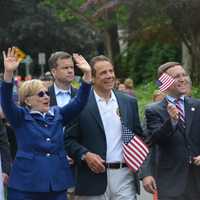 <p>Hillary Clinton waves as she marches in New Castle&#x27;s Memorial Day parade, which went through downtown Chappaqua. Pictured with her, left to right, are Gov. Andrew Cuomo, state Assemblyman David Buchwald and New Castle Councilman Jeremy Saland.</p>