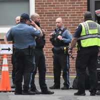 <p>Law enforcement officers gather outside Ridgewood High School following what was deemed an unfounded &quot;swatting&quot; call of someone with a gun.</p>