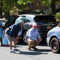 <p>Emergency responders inspect the van involved in the accident.</p>