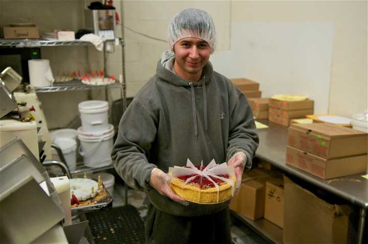 Preparing cheesecake at Carousel Cakes.