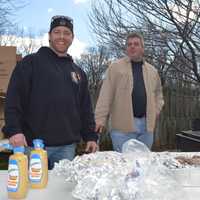 <p>Members of the Closter Fire Department work the grill.</p>