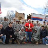 <p>Former Closter Police Sgt. Don Nicoletti, bottom row, second from left, military members from the Teaneck Armory and friends break from sorting and loading.</p>