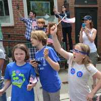 <p>Kids with Hillary Clinton campaign stickers watch the local Memorial Day parade in downtown Chappaqua. Clinton, a Democratic presidential candidate, is a Chappaqua resident.</p>