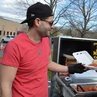 <p>Johnny Meatballs feeds a member of the Paramus Police Motorcycle Unit.</p>