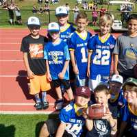 <p>Some future varsity players watch the game from the sidelines.</p>