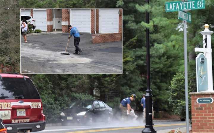 Firefighters and employees of the trash hauler sopped up the spill.