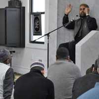 <p>Imam Muhammad Tahir addressing the men at Masjid Al-Aisha. Some women listened separately in an adjoining room. Because of child-rearing responsibilities, one explained, women are allowed to pray at home.</p>