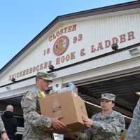 <p>Military members from the Teaneck Armory lend hands.</p>