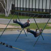 <p>A pair of journalists ride on swings at Douglas G. Grafflin Elementary School in Chappaqua. The journalists were part of a large media gaggle on hand to cover Hillary Clinton casting her vote in New York&#x27;s Democratic presidential primary.</p>