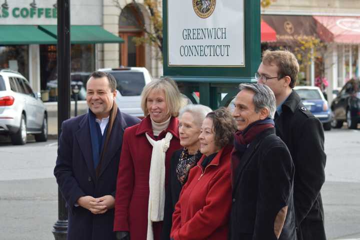 Officials pose in front of a new sign that marks the Greenwich Municipal Center Historic District on Monday. The sign is one of nine that will be placed throughout town. 