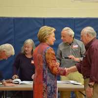 <p>Hillary Clinton chats with an election worker at Chappaqua&#x27;s Douglas G. Grafflin Elementary School. The building serves as Clinton&#x27;s polling place for the Democratic presidential primary. Former President Bill Clinton is pictured checking in.</p>