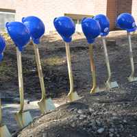 <p>Shovels and hard hats are lined up for a ceremonial groundbreaking at Chappaqua Crossing.</p>