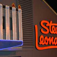 <p>Rabbi Yehoshua Hecht lights the menorah at Stew Leonard&#x27;s in Norwalk Monday.</p>