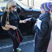 <p>Doreen Frega of Saddle Brook gives a Saddle River shopper a flier on the dangers of bow hunting deer in the borough.</p>