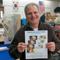 <p>Ridgefield illustator Chris Calle holds some of the covers he designed.</p>