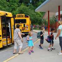 <p>Students step off the bus at Buchanan-Verplanck Elementary School.</p>