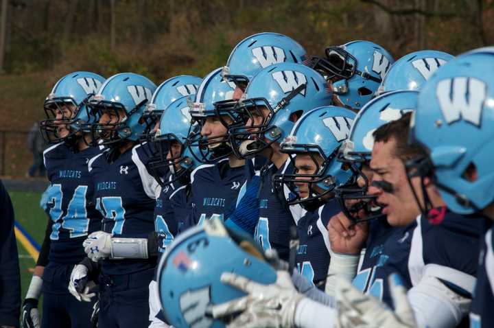 The Wildcat sideline watches the action on the field.