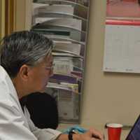 <p>Dr. Henry Lau, a volunteer physician, working at Bergen Volunteer Medical Initiative in Hackensack.</p>