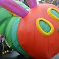 <p>Stamford Mayor David Martin works to bring The Very Hungry Caterpillar until some wires during the preview to the 24th annual Stamford Downtown Parade Spectacular.</p>