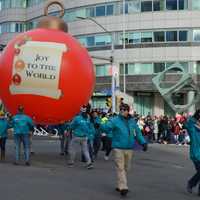 <p>Two floating Christmas ornaments were the first balloons in the Stamford Downtown Parade Spectacular Sunday.</p>