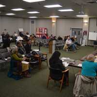 <p>Members of Save Our Shelton held up signs during a Planning &amp; Zoning meeting about the Towne Center at Shelter Ridge proposal.</p>