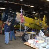 <p>Richie Jersey left and Mark Corvino work on the Corsair that will be one of the points of pride in the Curtiss Hangar annex of the Connecticut Air and Space Center.</p>