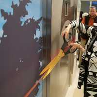 <p>Nancy Karch cuts the ribbon on one of the operating suites.</p>