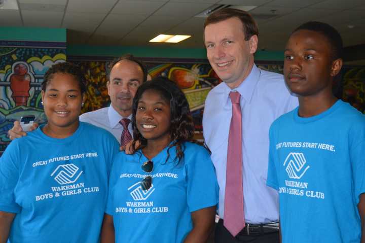 U.S. Sen. Chris Murphy, second from right, and Bridgeport Mayor Joe Ganim, second from left, pose with members of the Smilow-Burroughs Clubhouse in Bridgeport.