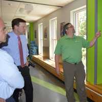 <p>Jason Macchia, right, explains the energy-efficient features at the Smilow-Burroughs Clubhouse in Bridgeport to Mayor Joe Ganim and U.S. Sen. Chris Murphy.</p>