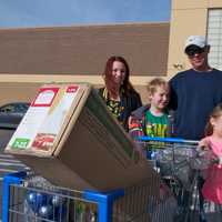 <p>Heading for the car with a cart full of goodies.</p>