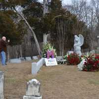 <p>A fan snaps a photo at Mary Tyler Moore&#x27;s final resting place in Fairfield&#x27;s Oak Lawn Cemetery.</p>