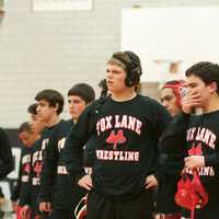 <p>Fox Lane wrestlers check out the action on a neighboring mat.</p>