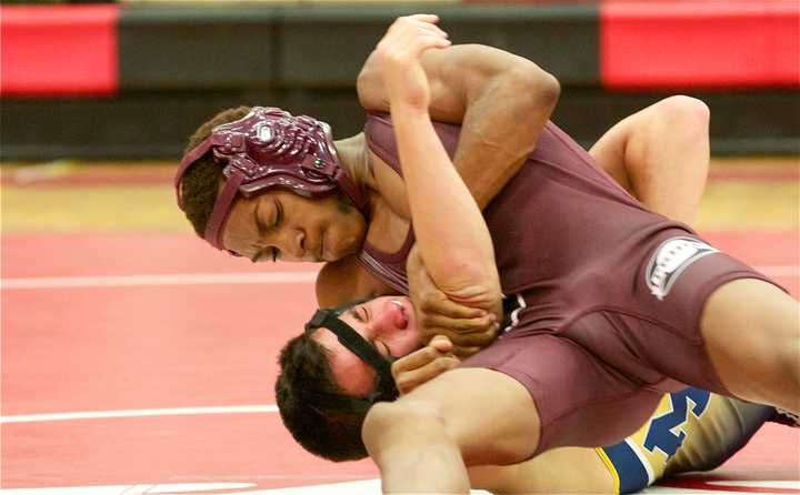 Ossining&#x27;s Clayton Francees (top) controls Alex Rabinowitz of Mahopac in a 120-pound bout.